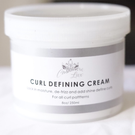 Curl Defining Cream on a bed.