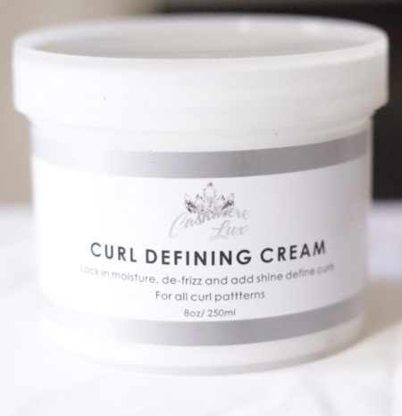 Curl Defining Cream on a bed.